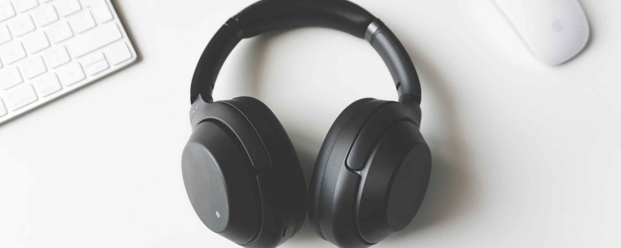 black earphones on a white desk