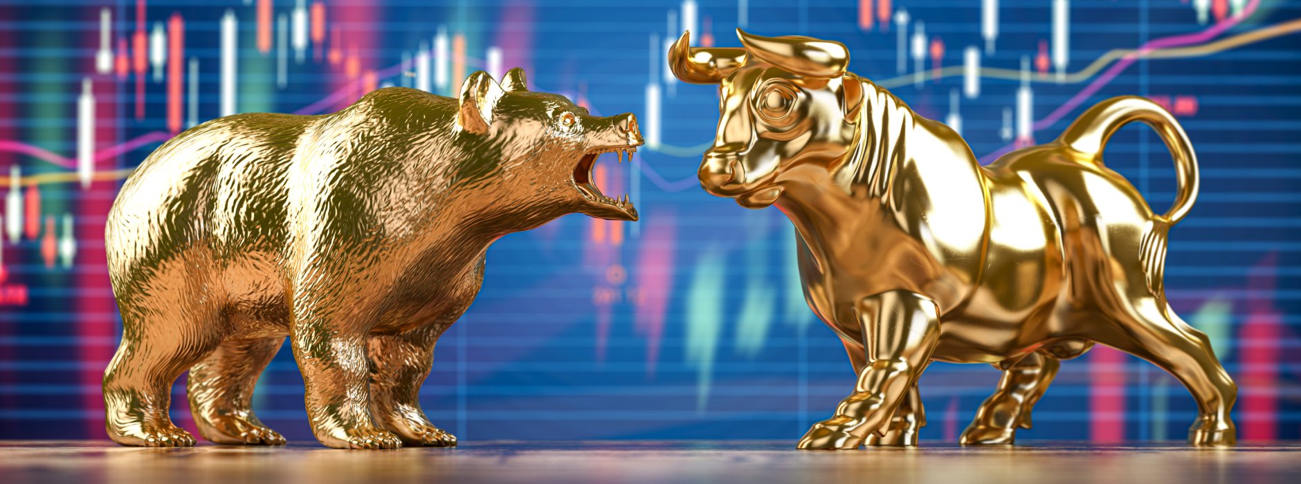 golden statues of a bear and a bull in front of a screen showing a trading chart