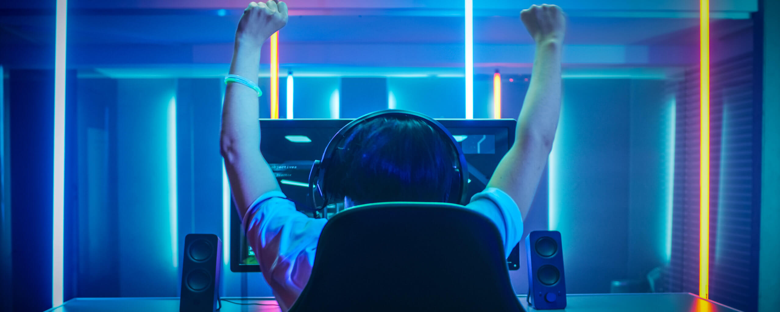 gamer in a winning pose with hands in the air