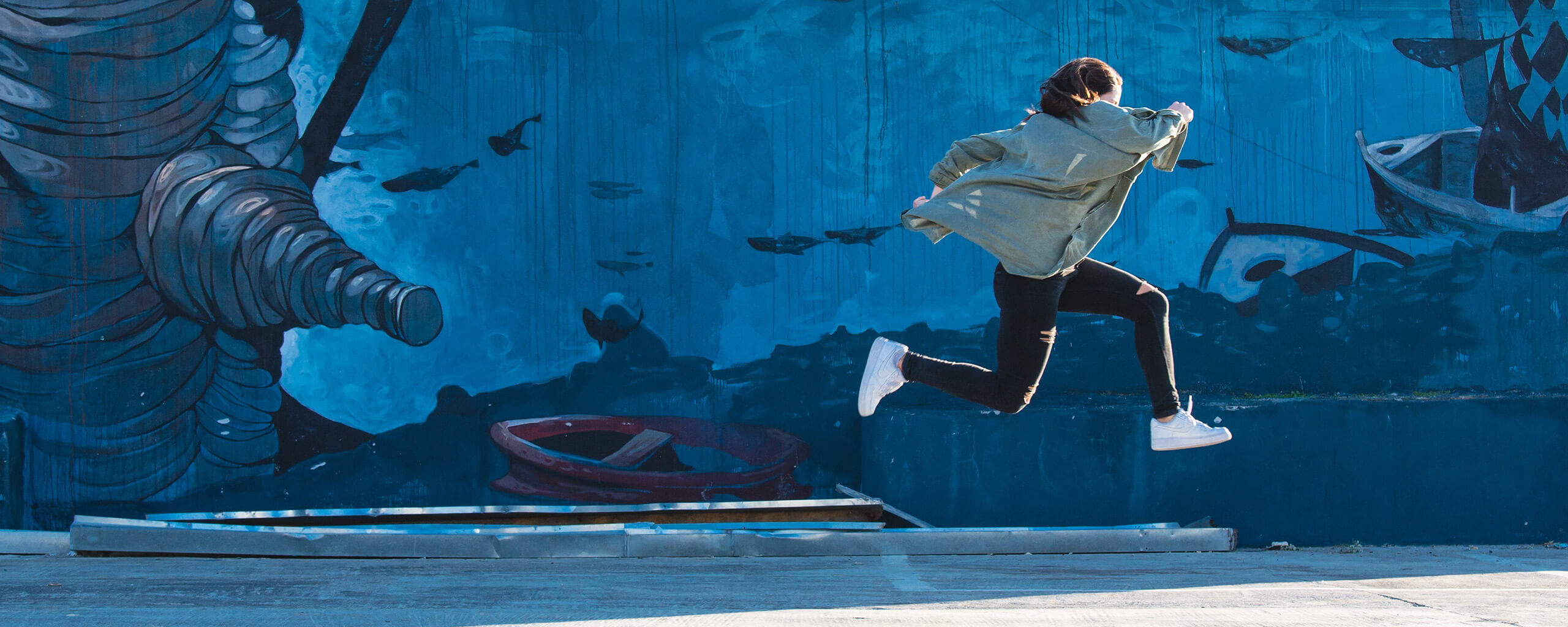 a girl jumping outside