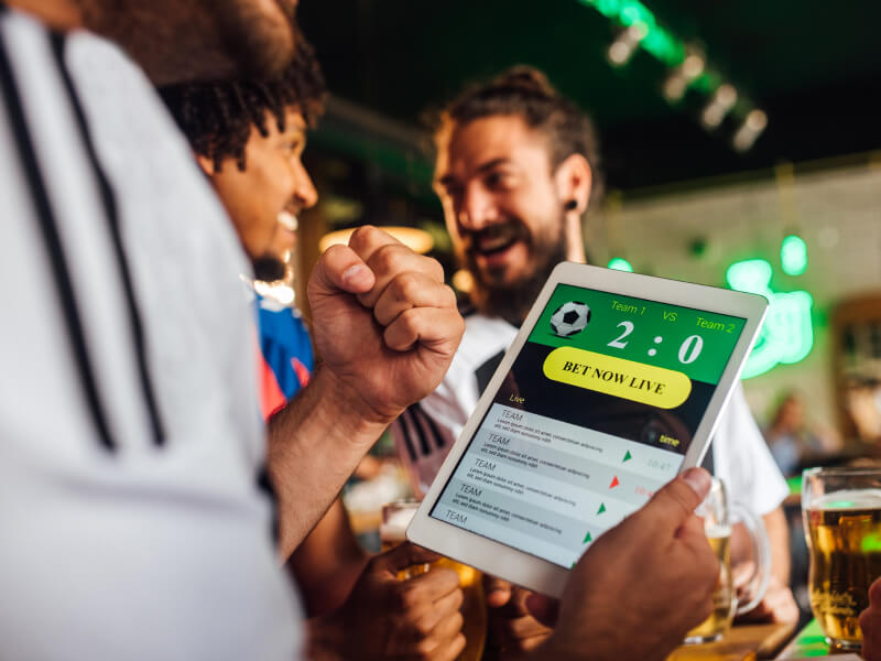 Person holding their tablet and betting on a football match