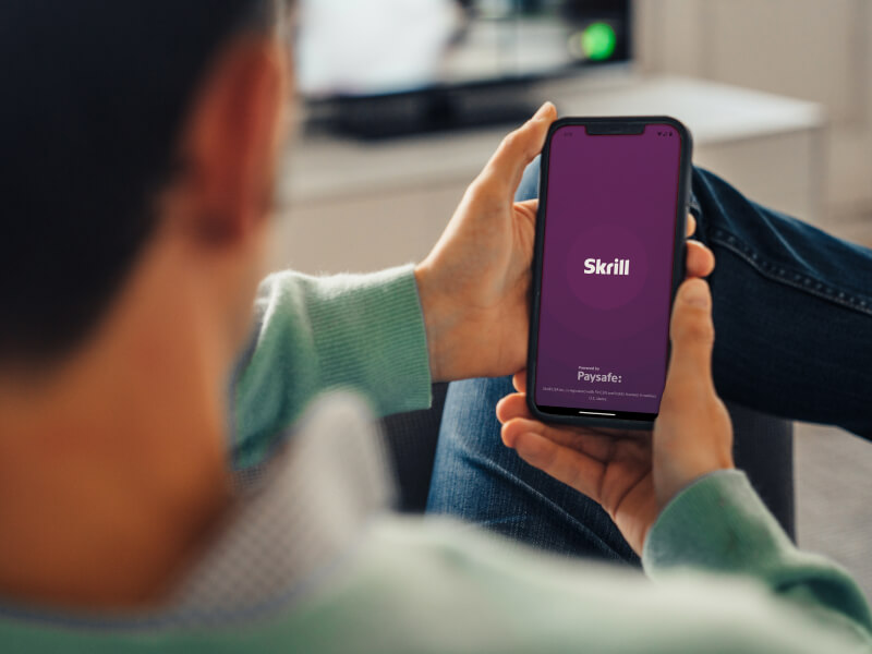 Person opening the Skrill mobile app