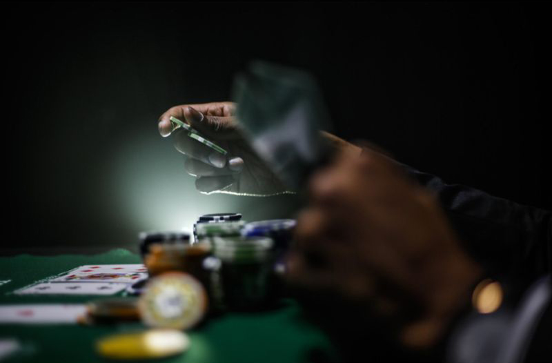 a man holding gambling chips