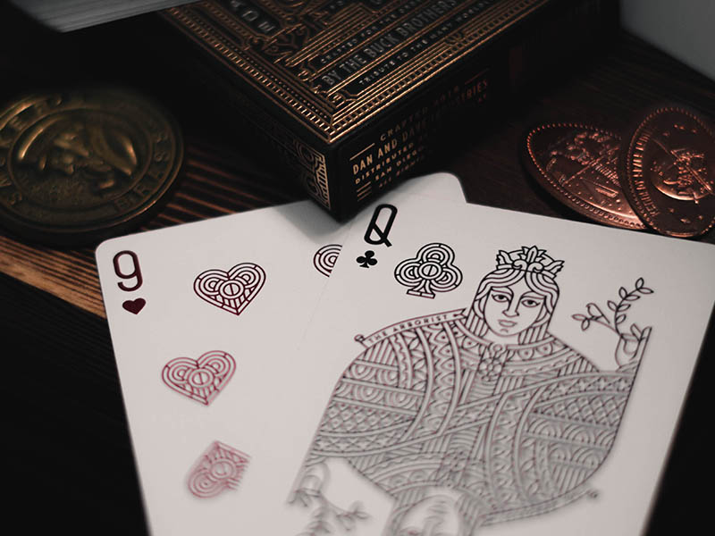 a nine and a Queen cards on a table