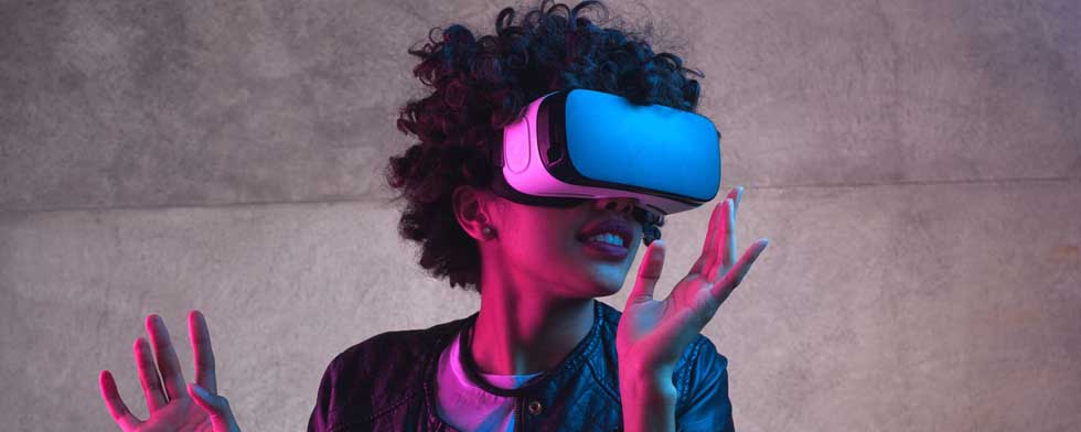 Curly woman wearing VR glasses